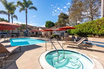 our apartments have a resort style pool with chairs and umbrellas